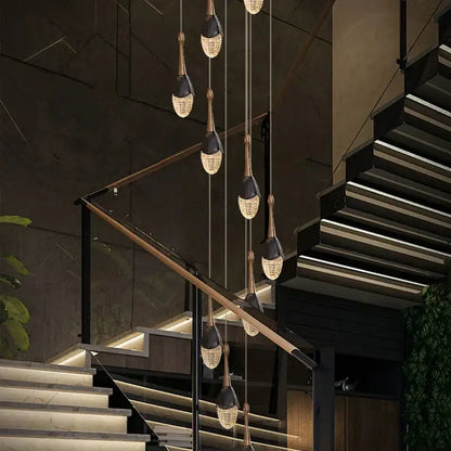 Luxury gold led staircase chandelier with black and gold finishes and crystal teardrop shades by decorbites gold led