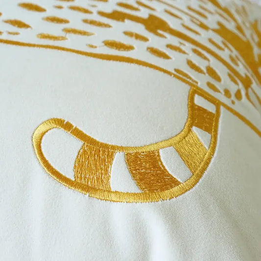 Luxury gold leopard velvet pillow case with a golden embroidered cat tail and gold thread stripes on white fabric decorbites