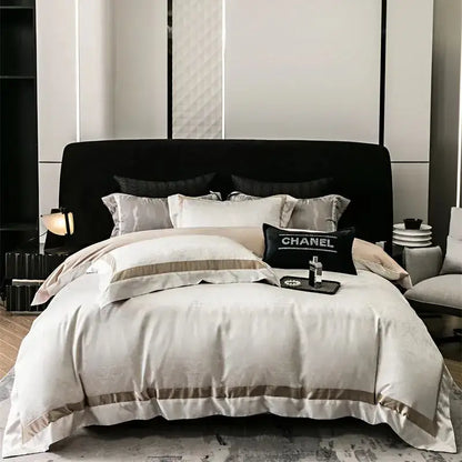 Cream-colored satin bedding set with taupe piping and black chanel pillow in luxury decorbites brocade satin jacquard style