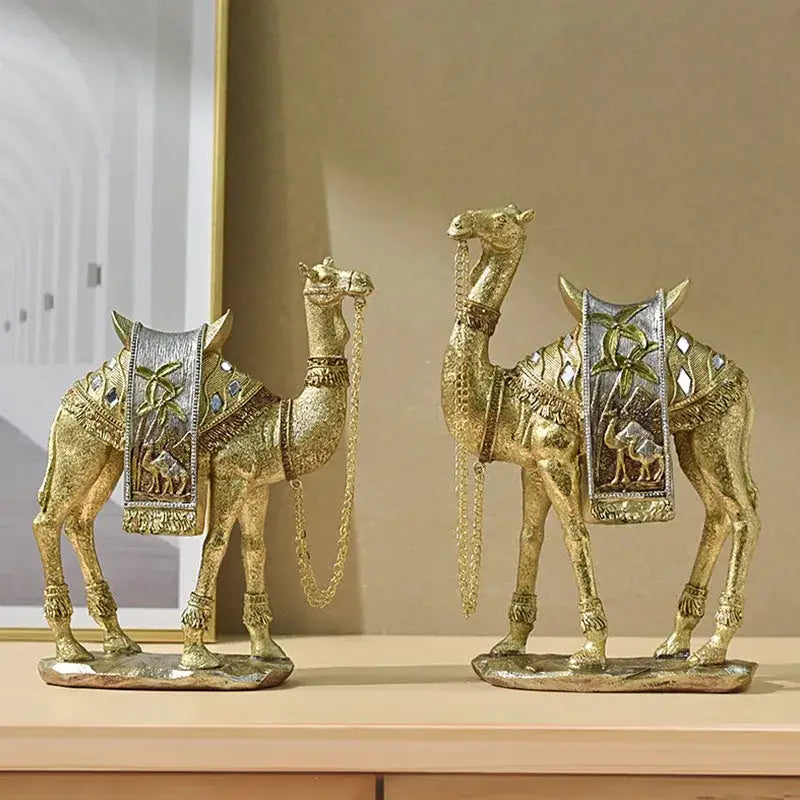 Two golden camel resin art ornaments with silver and gold embellishments for luxury living room decor