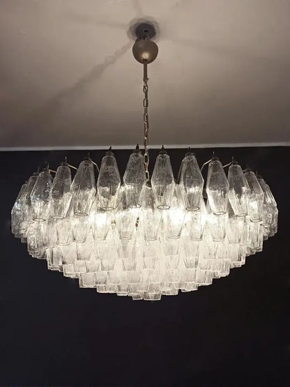 A decorbites gray glass chandelier with smoked crystal tiers and faceted glass shades for dining room lighting