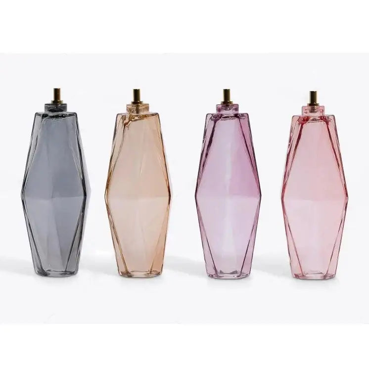 Four geometric glass perfume bottles with gold caps in gradient hues complement decorbites gray glass chandelier