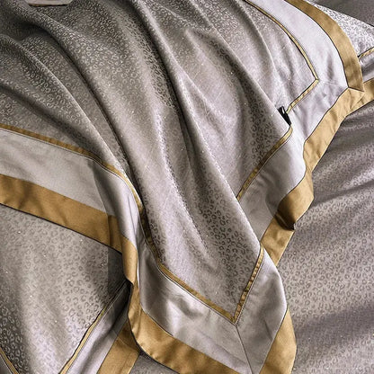 Luxurious silver-gray satin pillowcase with subtle cotton leopard jacquard pattern and gold trim from egyptian cotton leopard bedding set