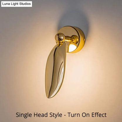 Luxury minimalist creative gold leaf-shaped wall sconce with polished finish and adjustable head for bedroom and living room