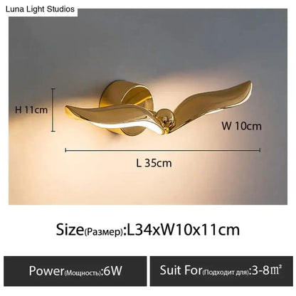 Gold-colored luxury minimalist creative seagull wall lamp shaped like a bird in flight for bedroom or living room