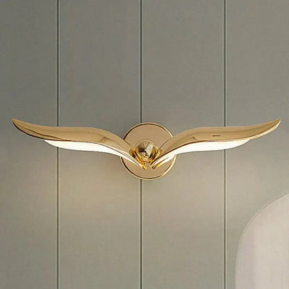 Gold-colored luxury minimalist creative seagull wall lamp with sleek wing-like arms for bedroom or living room use