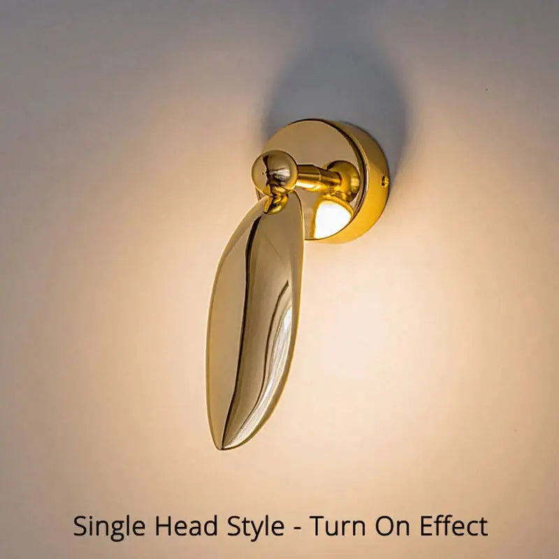 Gold-finished luxury minimalist creative seagull wall lamp with sleek leaf-shaped polished metal for bedroom or living room