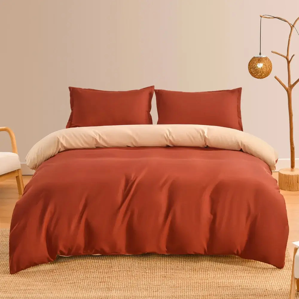 Luxury rust-colored satin duvet cover set with cream inner lining and matching pillows for elegant bedroom bedding