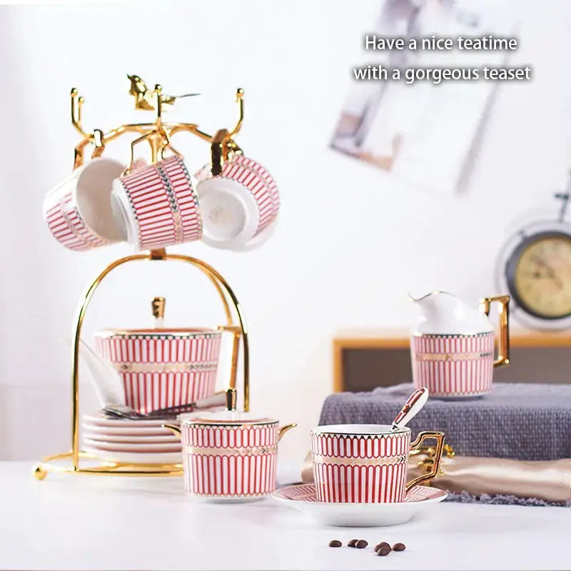 Luxury red and gold porcelain coffee set with pink and white striped teacups on a decorbites gold porcelain serving rack
