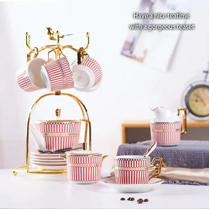 Luxury red and gold porcelain coffee set with pink and white striped teacups on a decorbites gold porcelain serving rack