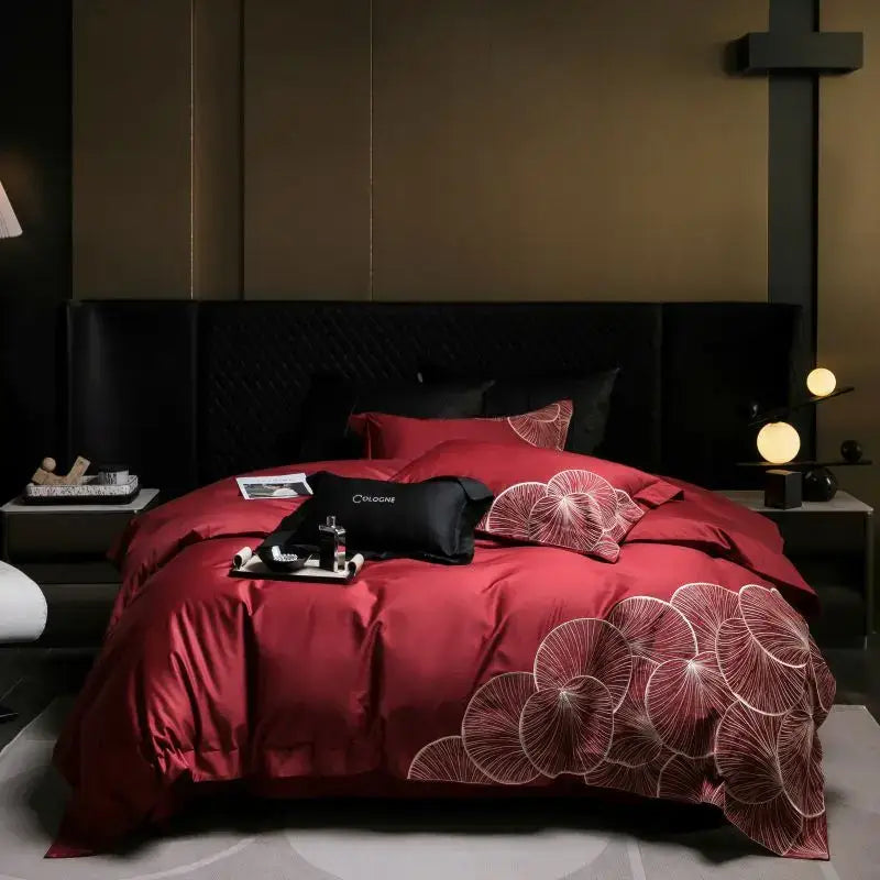 Luxury red satin duvet cover with white embroidered lotus patterns in a cotton bedding set for bedroom use