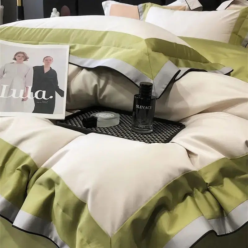 A plush bedding set in sage green and cream with silver trim made from 1000tc egyptian cotton luxury fabric