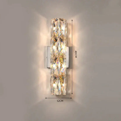 Luxury silver crystal wall sconce with stacked faceted segments refracting warm light for living room decorbites crystal deluxe