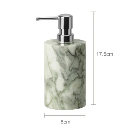 A sleek cylindrical soap dispenser with a white and green marble body and chrome pump in an emerald marble bathroom set