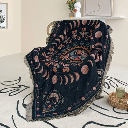 Black throw blanket with intricate moon floral patterns and fringe used as mandala geo tassel picnic mat or sofa cover