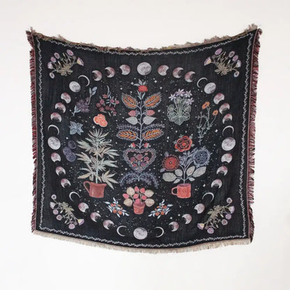 Black woven throw blanket with fringed edges and botanical lunar phase design as geo tassel picnic mat and sofa cover