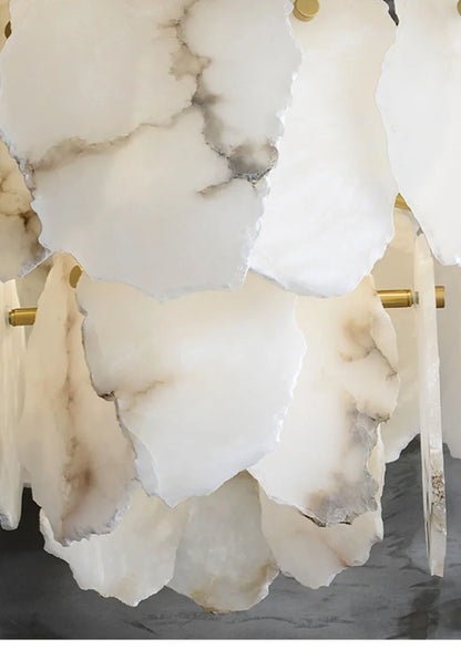 A marble led chandelier round pendant light with layered white and gray marble-like petals and gold-toned rods