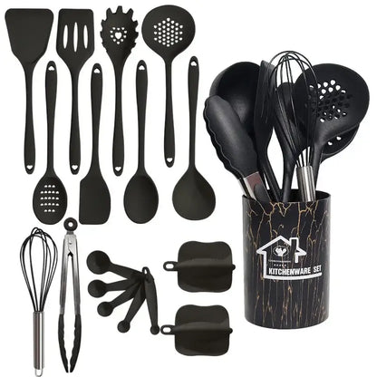 Black silicone cooking tool set in a black and gold marble-patterned cylindrical kitchen storage container