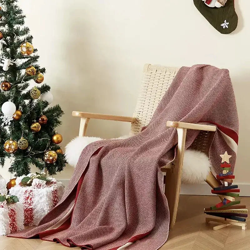 Maroon and red cozy striped knit blanket with herringbone weave draped on wooden rocking chair for decorbites cozy striped use