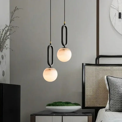 Matte black and polished copper pendant light with frosted glass globes for dining room and marble pendant light decor