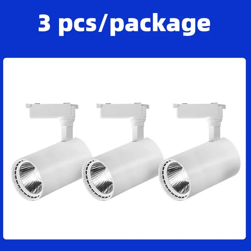 Three white cylindrical track lighting fixtures with adjustable heads for chandelier track ceiling by decorbites cob chandelier