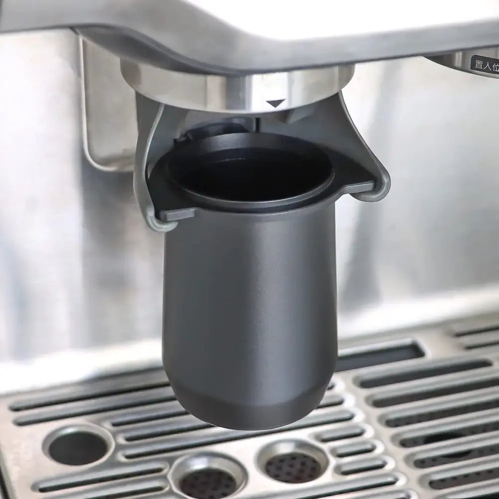 Matte black espresso dosing cup with handle featuring a sleek cylindrical design and black matte finish for espresso dosing