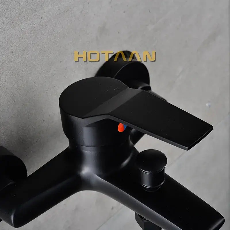 Matte black finish shower faucet with handheld mixer featuring modern angular design and orange indicator dot decorbites black finish