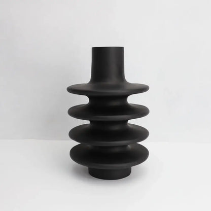 Matte black ceramic vase with stacked tiered rings and geometric circle spiral design for living room decor