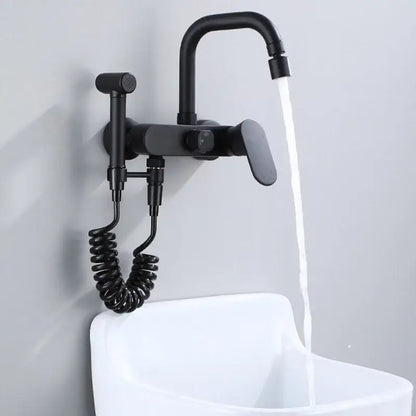 Matte black kitchen mixer tap with wall-mounted curved spout and integrated handheld showerhead on coiled hose