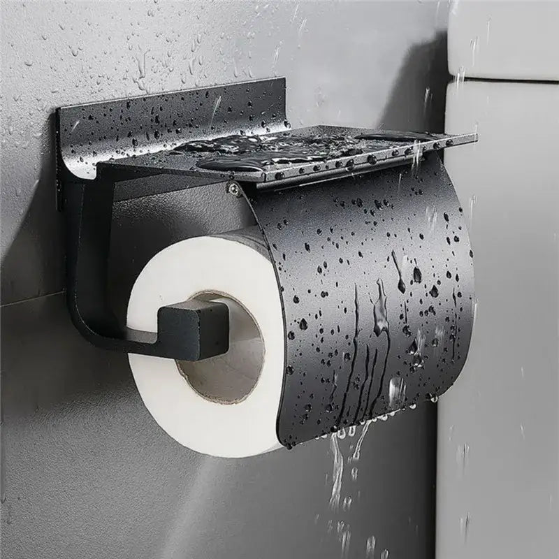 Matte black metal toilet paper holder with shelf and integrated rain shield for bathroom storage and paper holder use