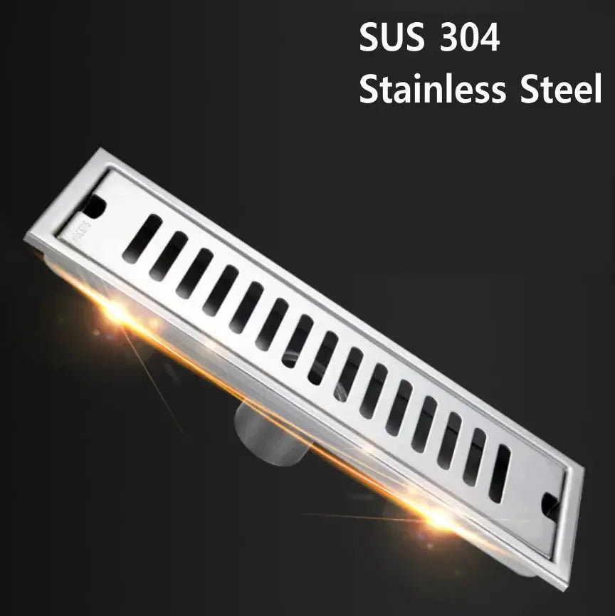 A sleek stainless steel strip floor drain with polished silver finish and vertical slits for bathroom shower use