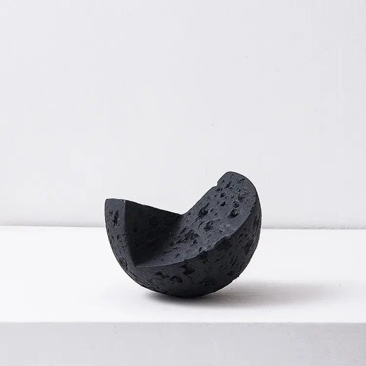 Matte blue geometric spherical home decoration accessory featuring a black volcanic stone crescent moon sculpture