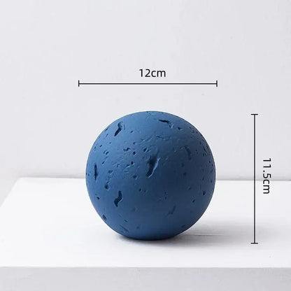 Matte blue geometric spherical home decoration accessory with textured cratered surface for living room decor