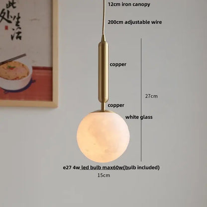 A warm glowing pendant light with a white glass globe and copper ceramic walnut decorbites ceramic walnut finish