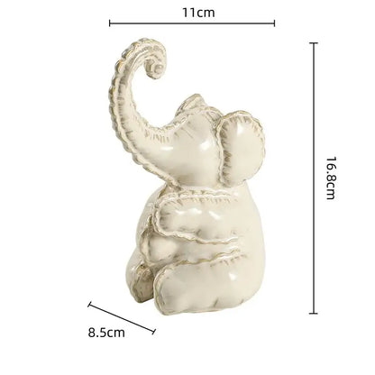 Cream-colored ceramic elephant figurine with glossy finish and textured features for home decor and decorbites elephant abstract