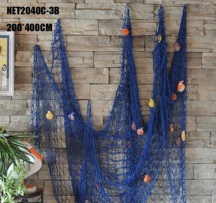 Mediterranean beige wall hanging decorbites decorative fishing net in deep blue with seashells against stone wall