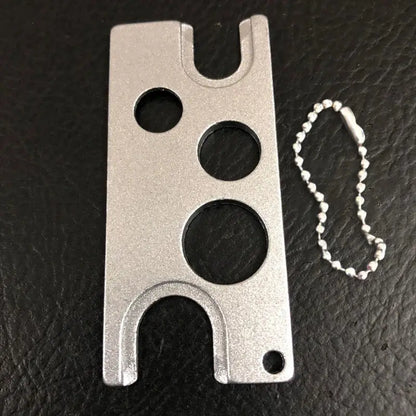 Silver metal multi-tool card holder with three circular cutouts and ball chain for decorbites essential oils opener