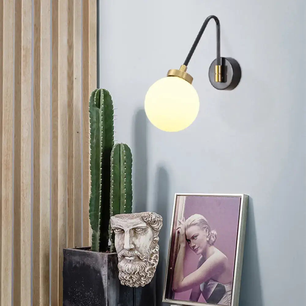 Mid century black and brass wall sconce with spherical frosted opal glass shade compatible with e26 e27 bulbs
