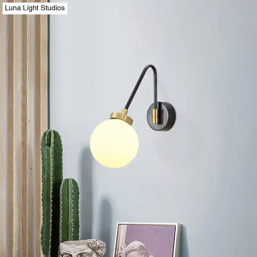 Modern black and brass wall sconce with spherical frosted opal glass shade compatible with e26 e27 bulbs for bedroom use
