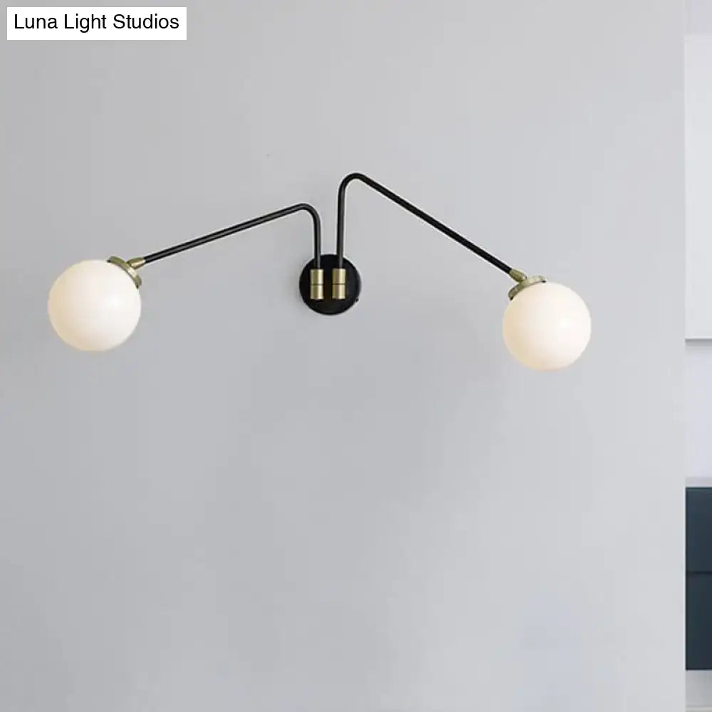 Mid century black and brass two-arm wall sconce with frosted opal glass globes compatible with e26 e27 bulbs