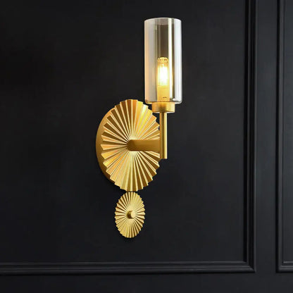 Mid century brass wall sconce with scalloped backplate amber glass shade and fan-like gold-toned metal plates