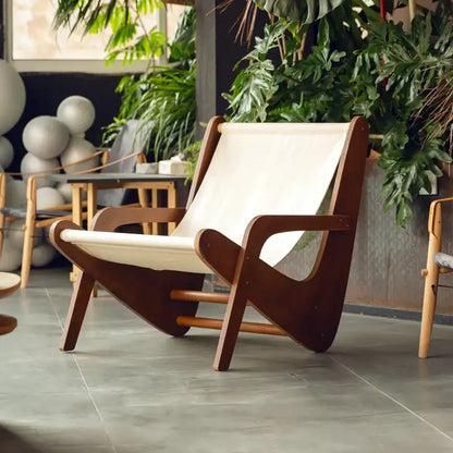 A mid-century brown and cream decorbites canvas recliner with a wooden frame for stylish living room seating