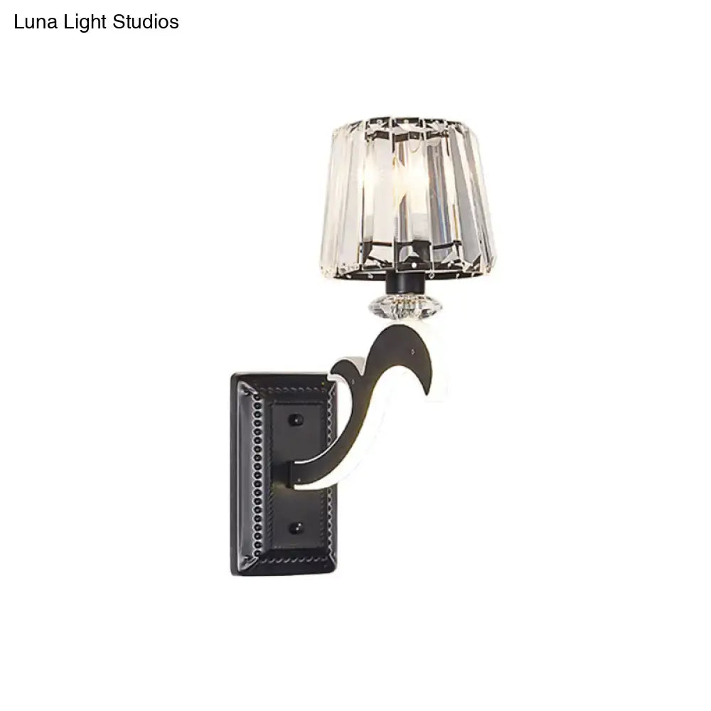 Black wrought iron wall lamp with faceted crystal cone shade ideal for minimal bedroom lighting decor