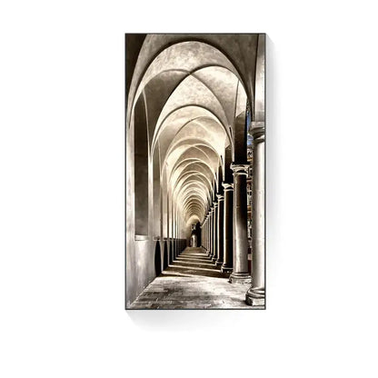 Black-and-white canvas print of a long arched stone corridor complements a minimalist beige abstract led wall lamp modern wall decor
