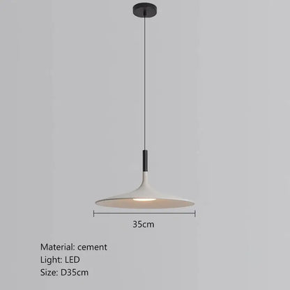 A sleek minimalist beige cement ufo led pendant light with matte white cement shade and black hardware for dining room