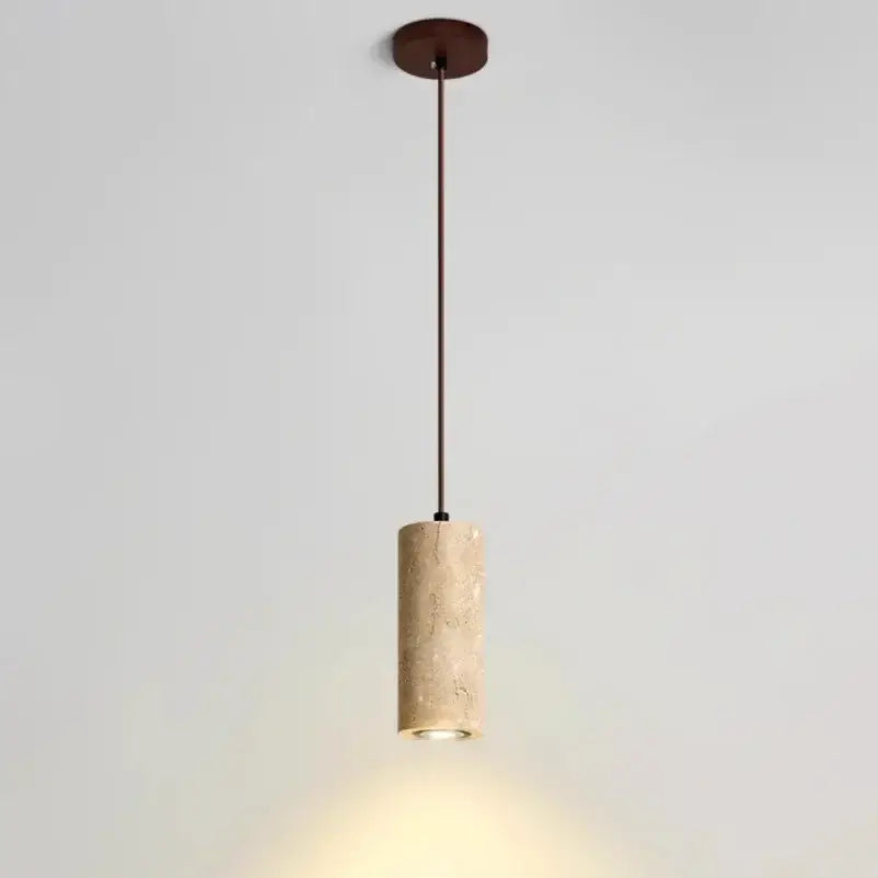 Minimalist beige travertine cylindrical pendant light with textured stone body and dark metal hardware for dining table