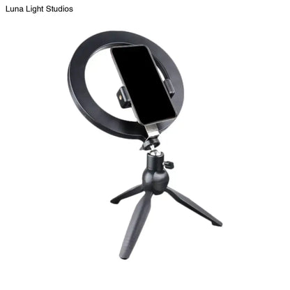 Minimalist black 14 inches fixture ring light with flash lighting mounted on tripod with phone holder for bedroom use