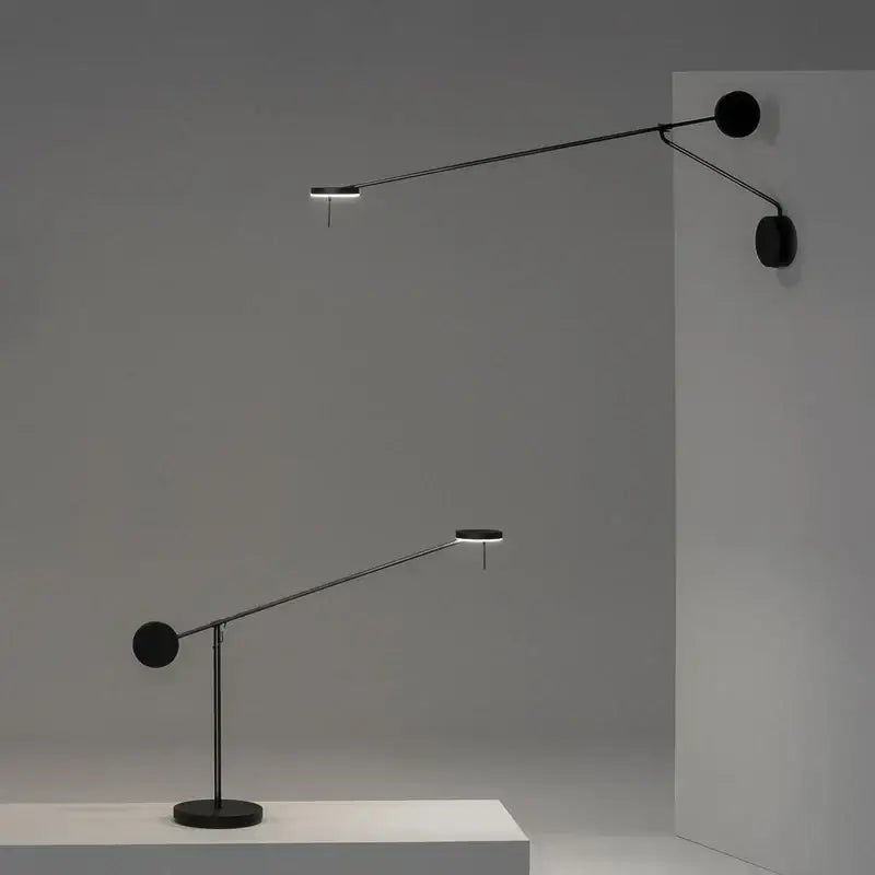 Minimalist black wall lamp with adjustable swing arm and sleek articulated design for bedroom lighting