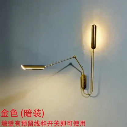 Gold-colored adjustable vintage wall lamp with articulated arms and cylindrical light fixture by decorbites for bedroom decor