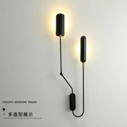 Minimalist black adjustable vintage wall lamp with a sleek cylindrical design and gold-toned accents for bedroom reading light